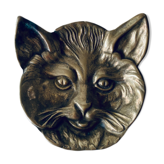 Empty brass feline head pocket