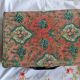 Old suitcase, red cashmere fabric, bohemian folk