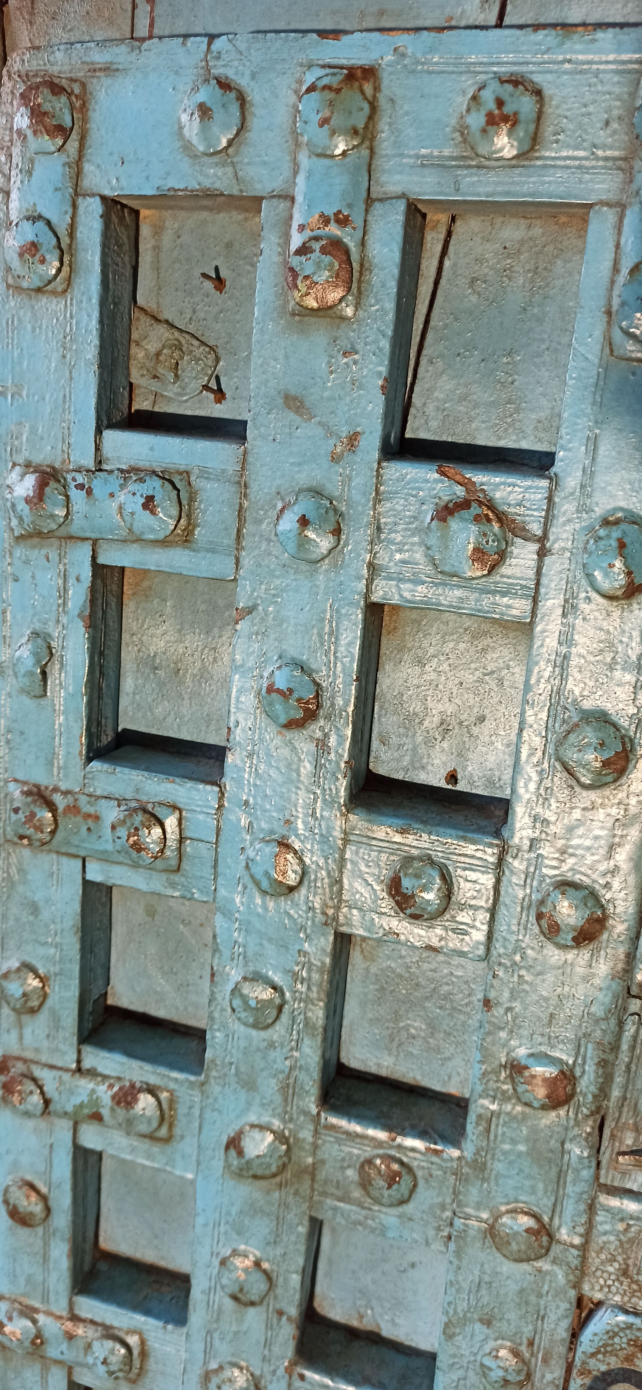 Old blue wooden door with braces
