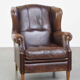 Wing chair made of sheepskin and neatly finished with black piping