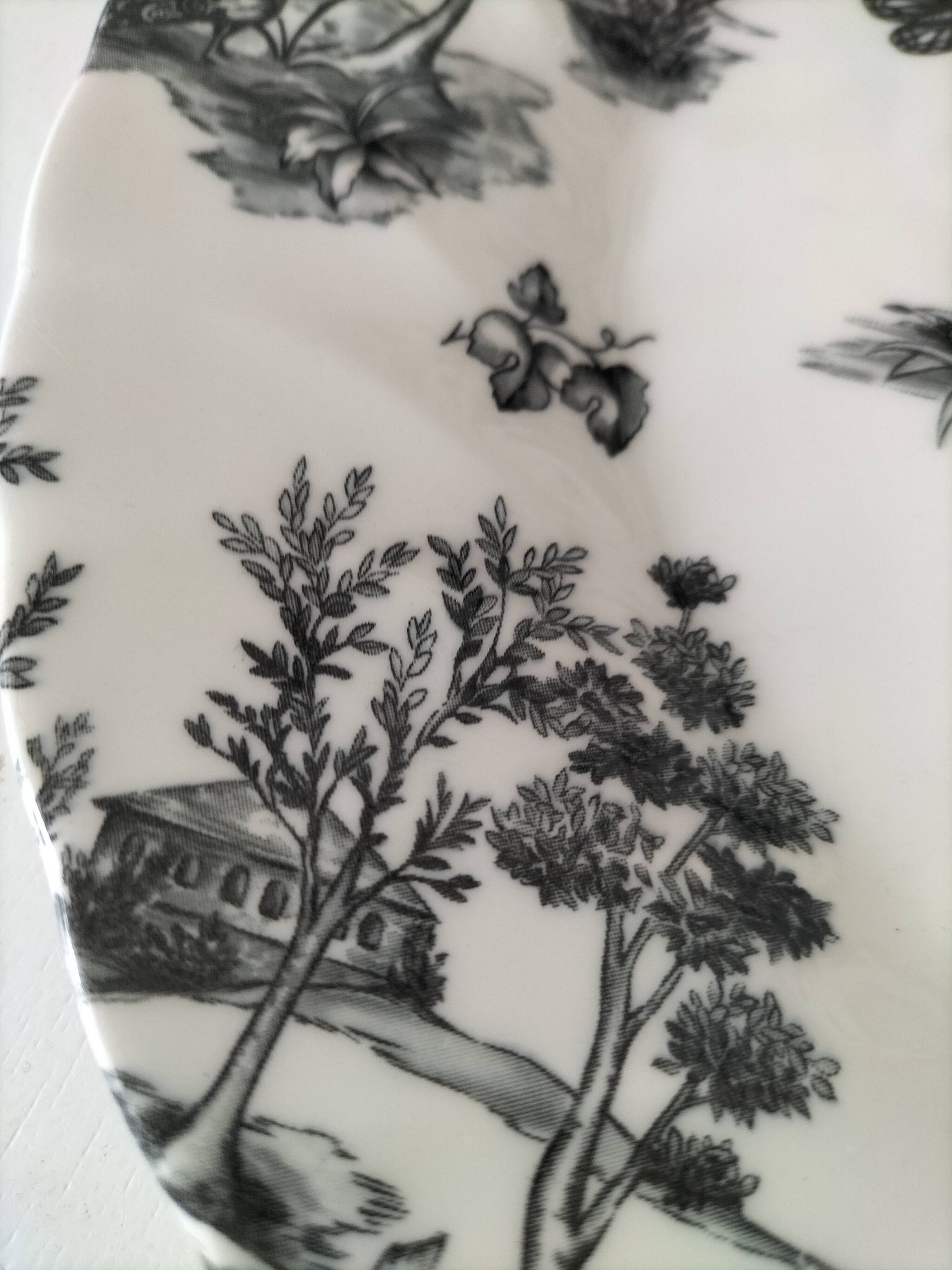 Set of black and white plates in the style of toile de Jouy.