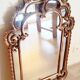 Antique mirror with rococo-style pareclose, in gilded wood, 19th century