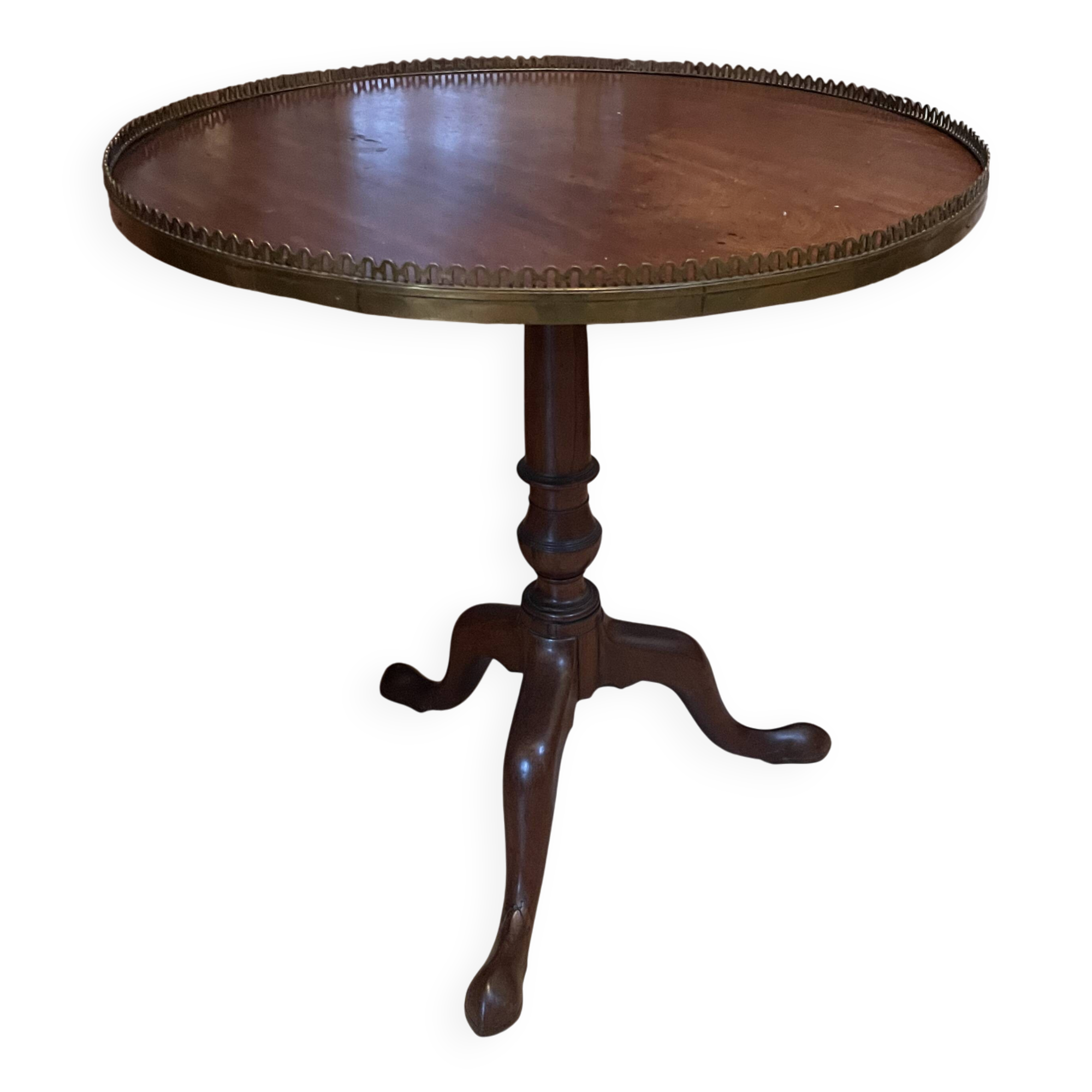 Foldable tripod side table in carved mahogany with brass trim.