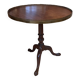 Foldable tripod side table in carved mahogany with brass trim.
