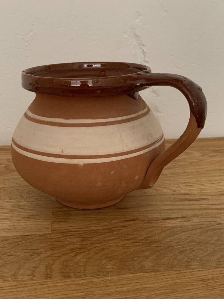 Hungarian folk ceramic pitcher in glossy brown and beige, traditional rounded pot.