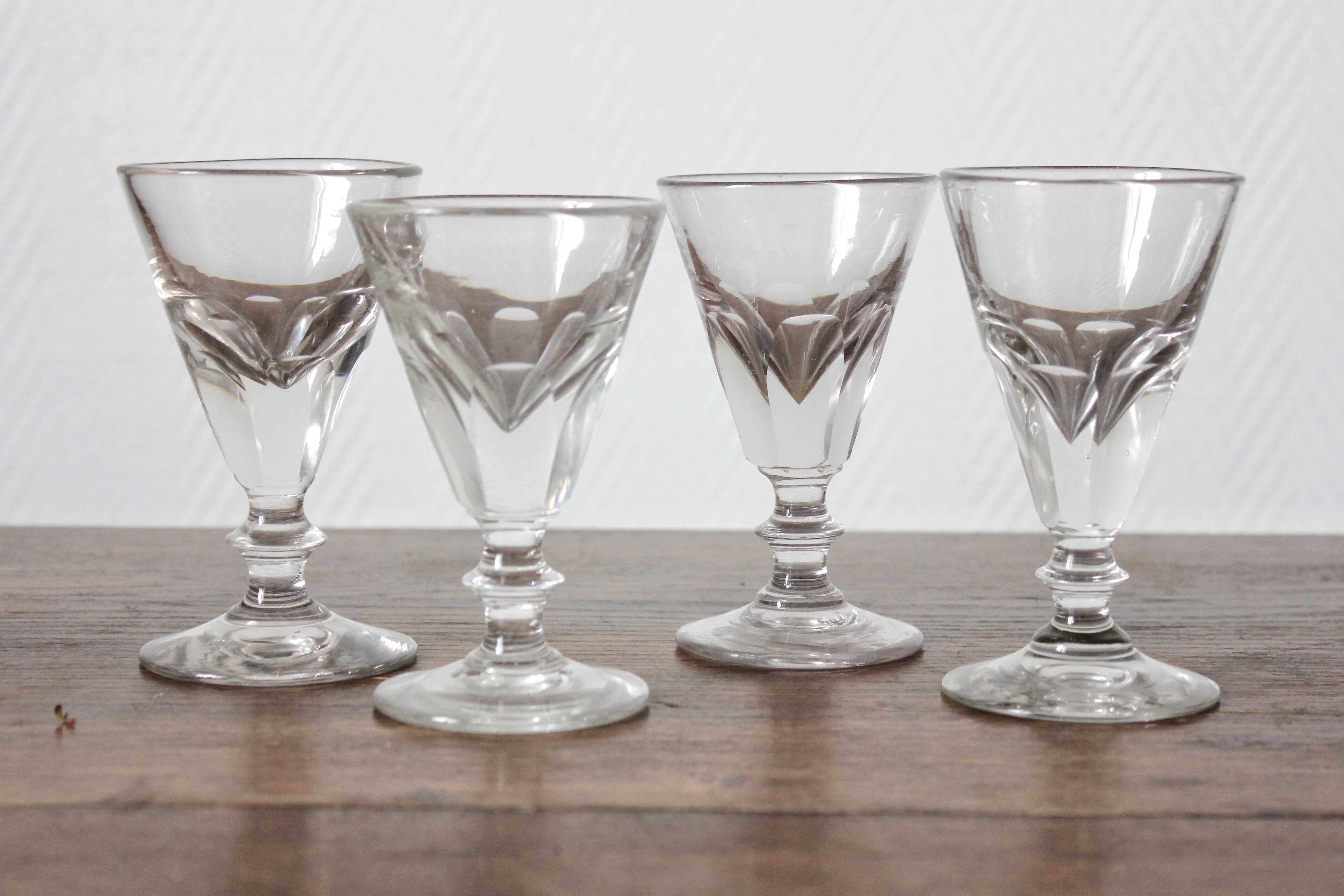 4 antique stemmed wine glasses with flat sides, made of blown glass from the 19th century