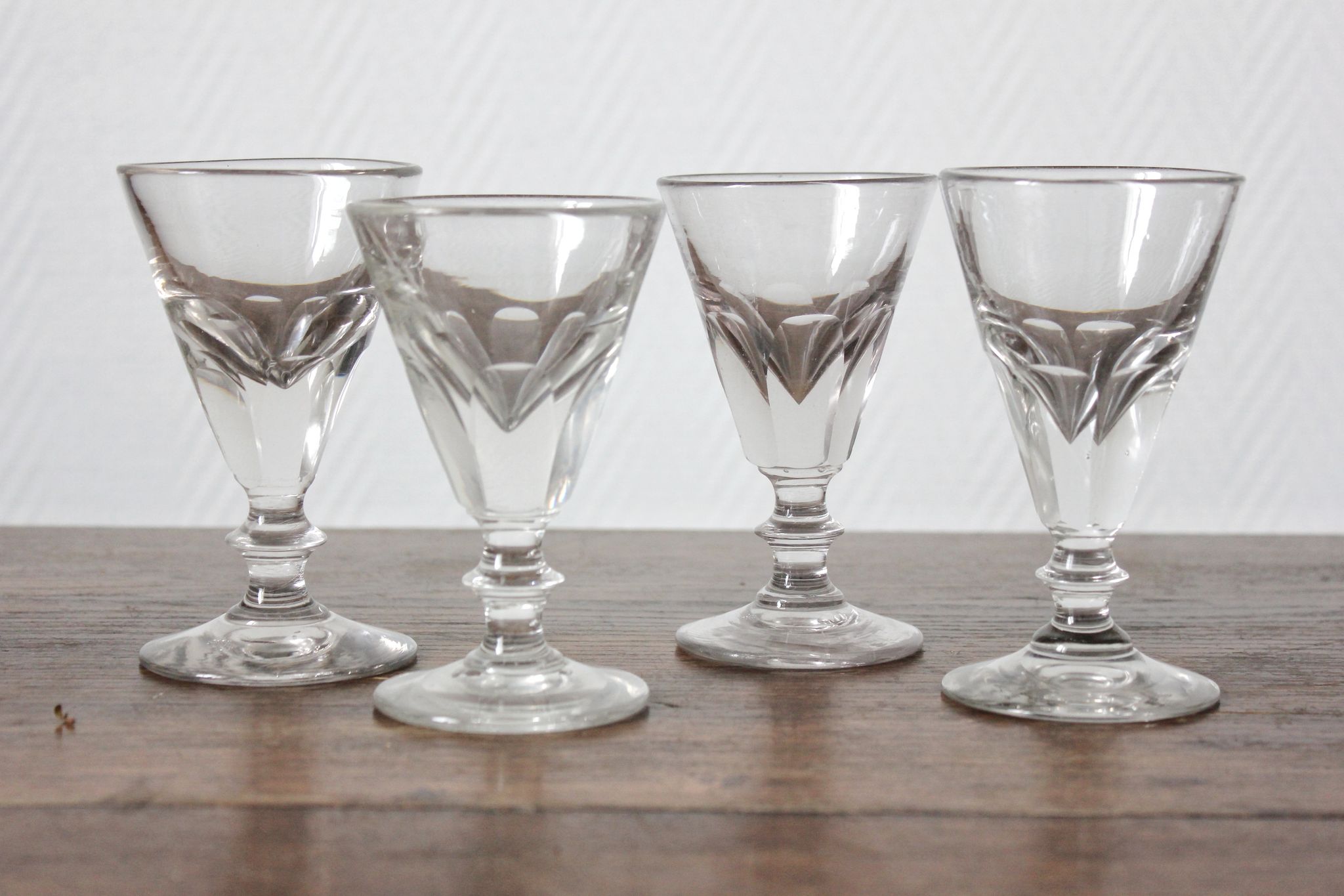 4 antique stemmed wine glasses with flat sides, made of blown glass from the 19th century