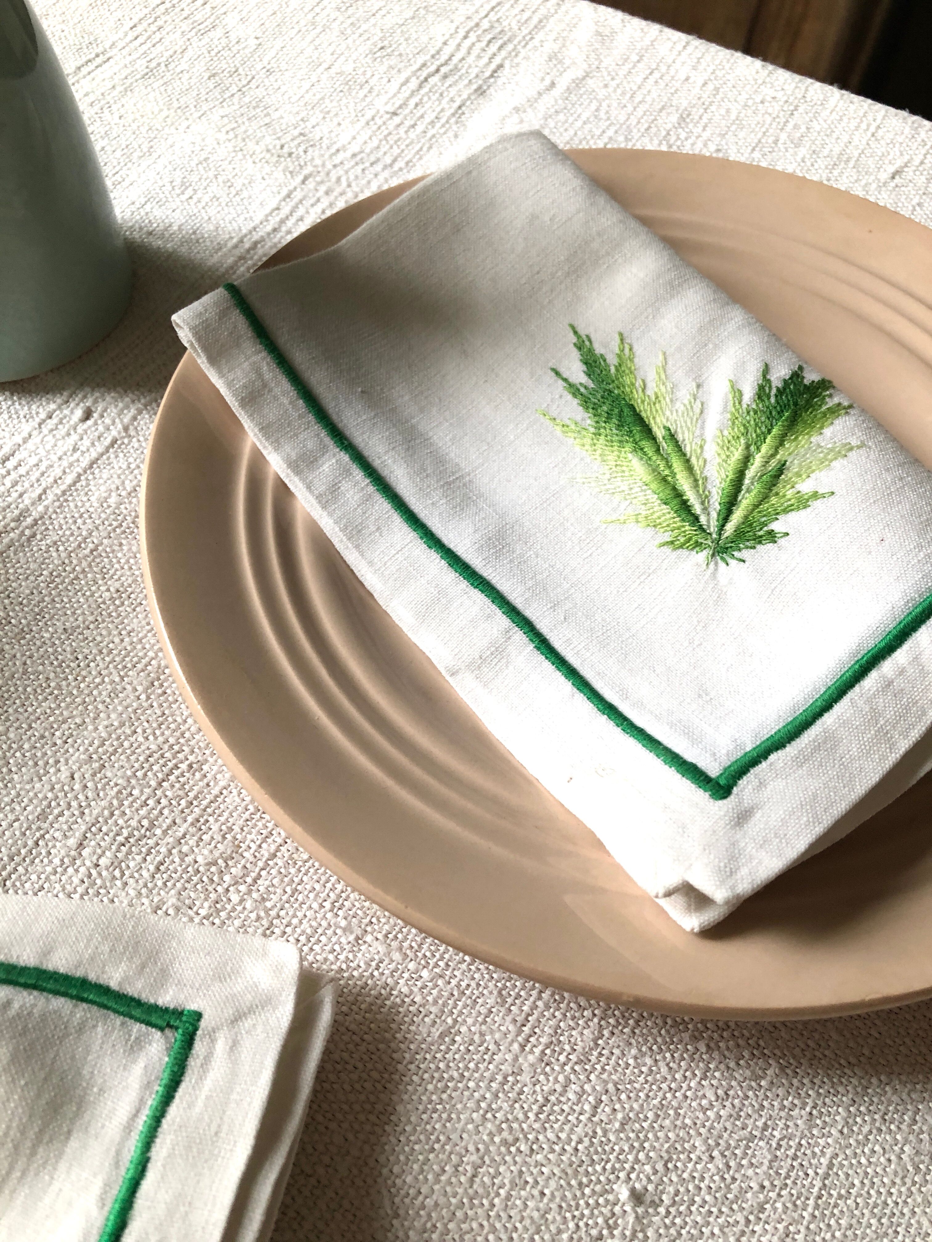 Series of four embroidered linen napkins