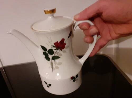 White porcelain coffee service of 3 pieces with a rose design.
