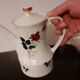 White porcelain coffee service of 3 pieces with a rose design.