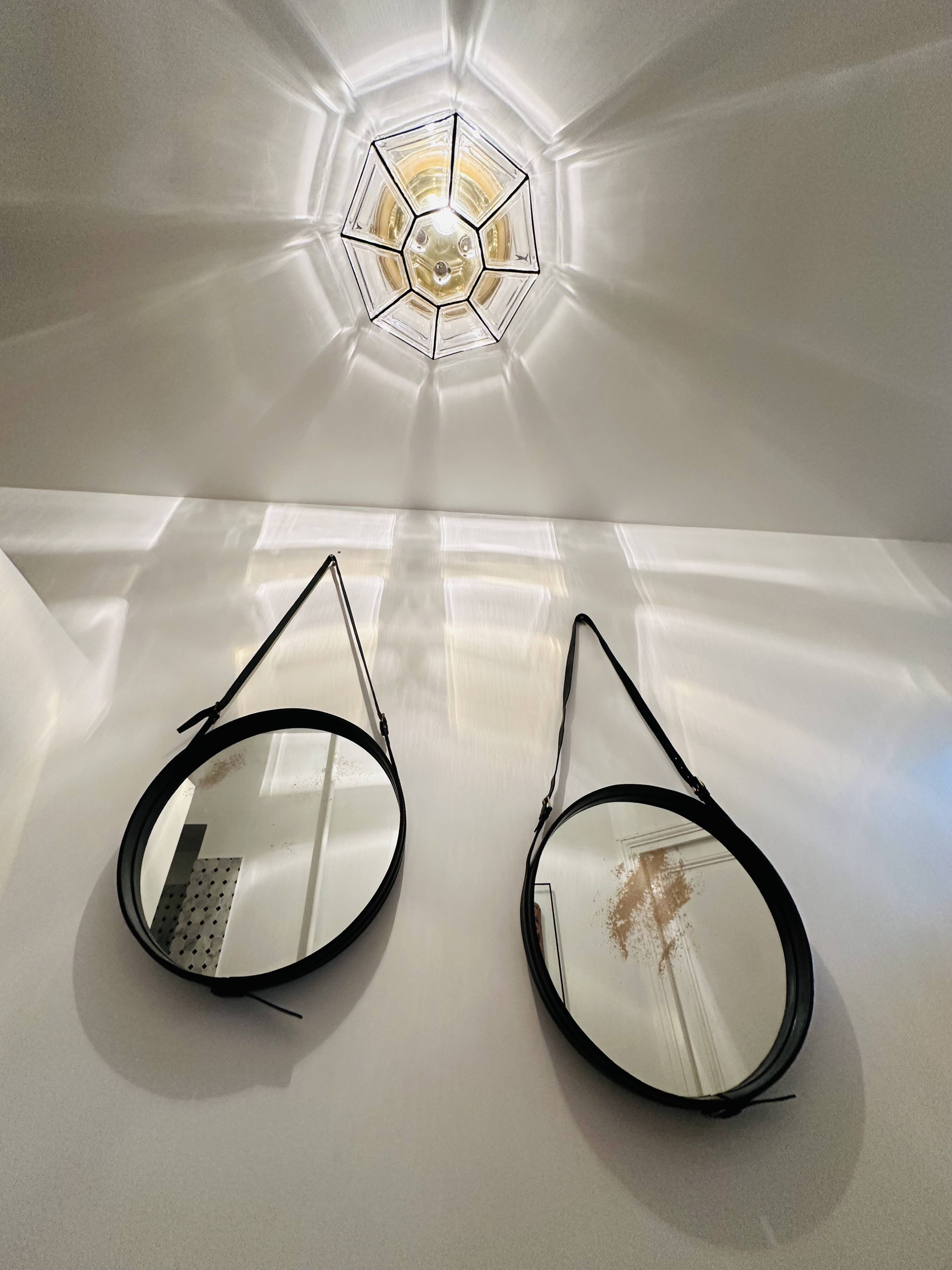 Jacques Adnet pair of circular leather and brass mirrors