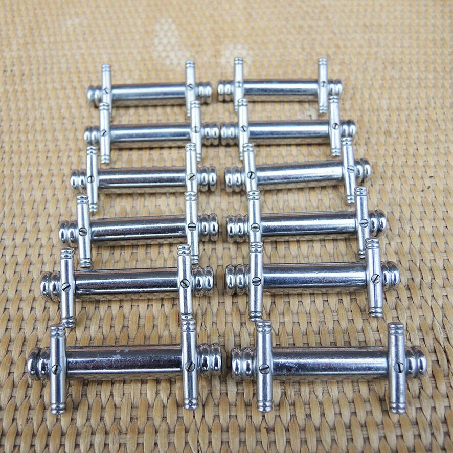 12 vintage Art Deco metal knife rests