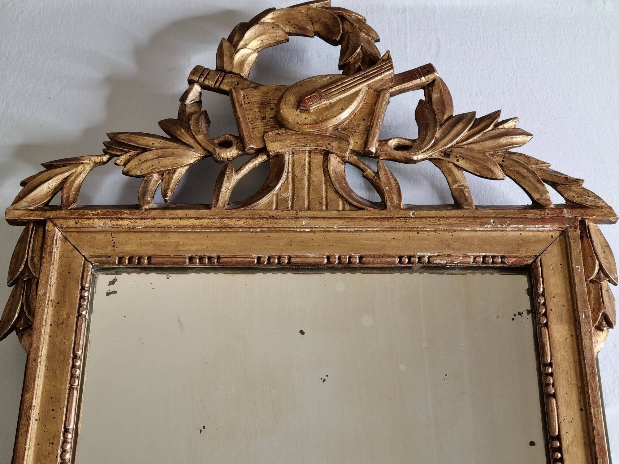 Antique carved and gilded wooden mirror, Louis XVI style – 54 x 92 cm