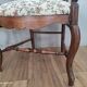 Pair of Provençal armchairs in brown wood and floral fabric.