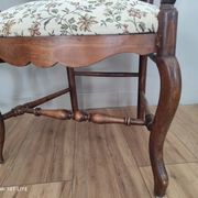 Pair of Provençal armchairs in brown wood and floral fabric.