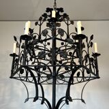 Lustre with 12 lights in wrought iron decorated with clovers and foliage.