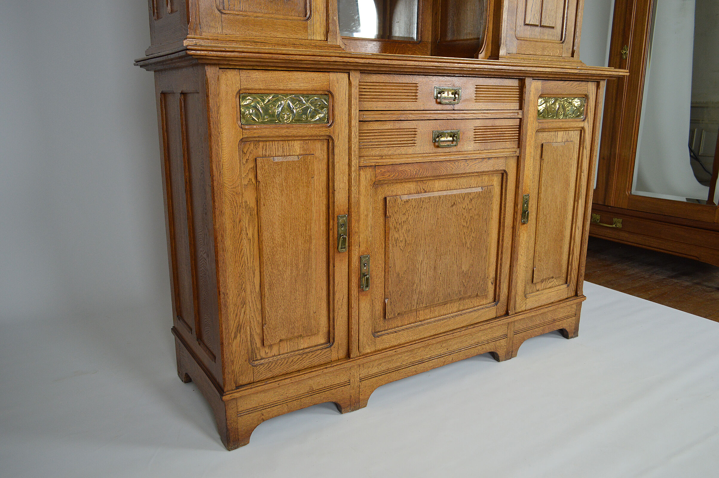 Art Nouveau oak buffet and dinanderie panels, circa 1910