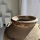 Very large grey and red terracotta pot with handles and rattan crossbars.