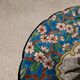 Longwy enamel plate with cartouche of 2 birds and apple blossoms, d188