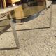 Table basse elliptique vers 1970 en métal chromé et verre fumé