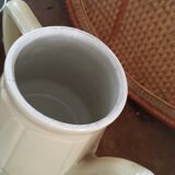 Old tea pot or coffee maker in faience cream with filter.