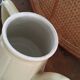 Old tea pot or coffee maker in faience cream with filter.
