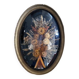 Vintage oval frame of dried flowers.