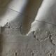 Pair of 19th century linen thread pillowcases embroidered with scallops