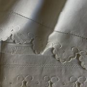 Pair of 19th-century linen pillowcases embroidered with scallops.