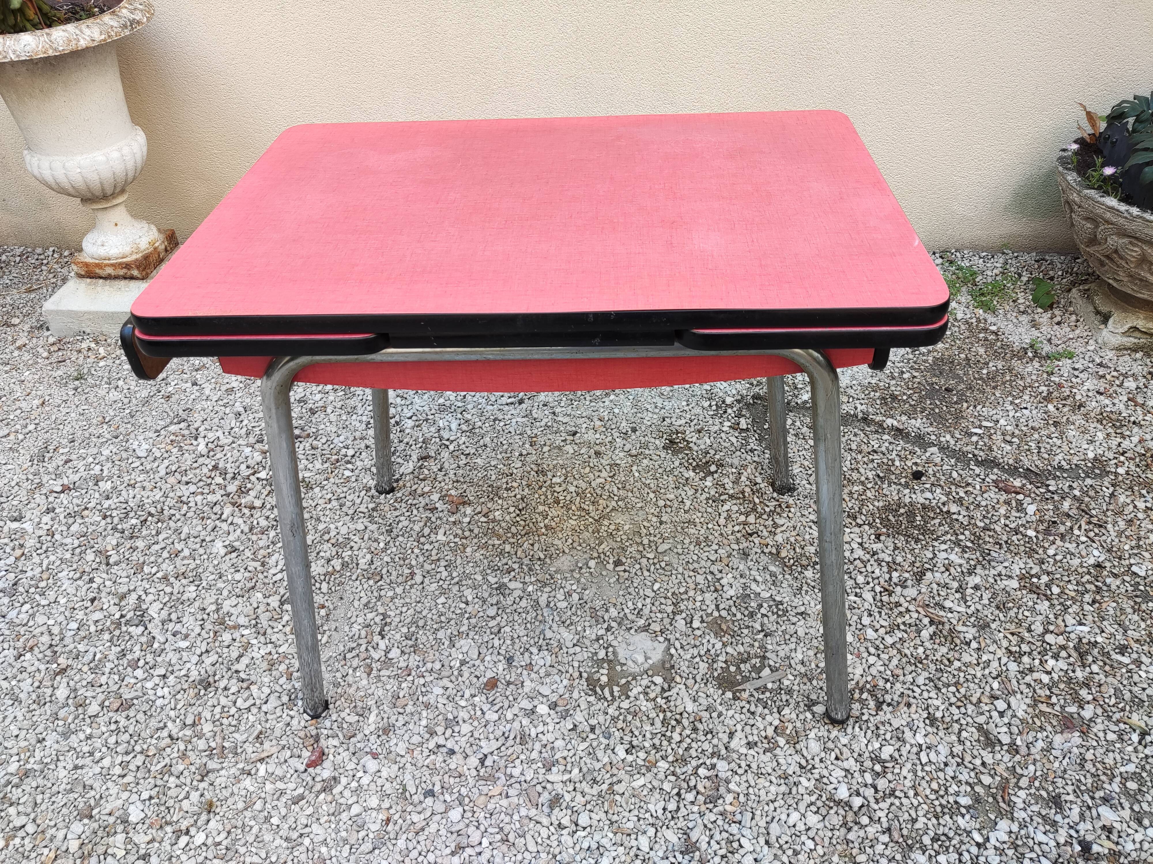 Table with two stools in red formica
