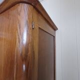 Vintage 1960s wooden wardrobe with a central mirror and tapered legs.