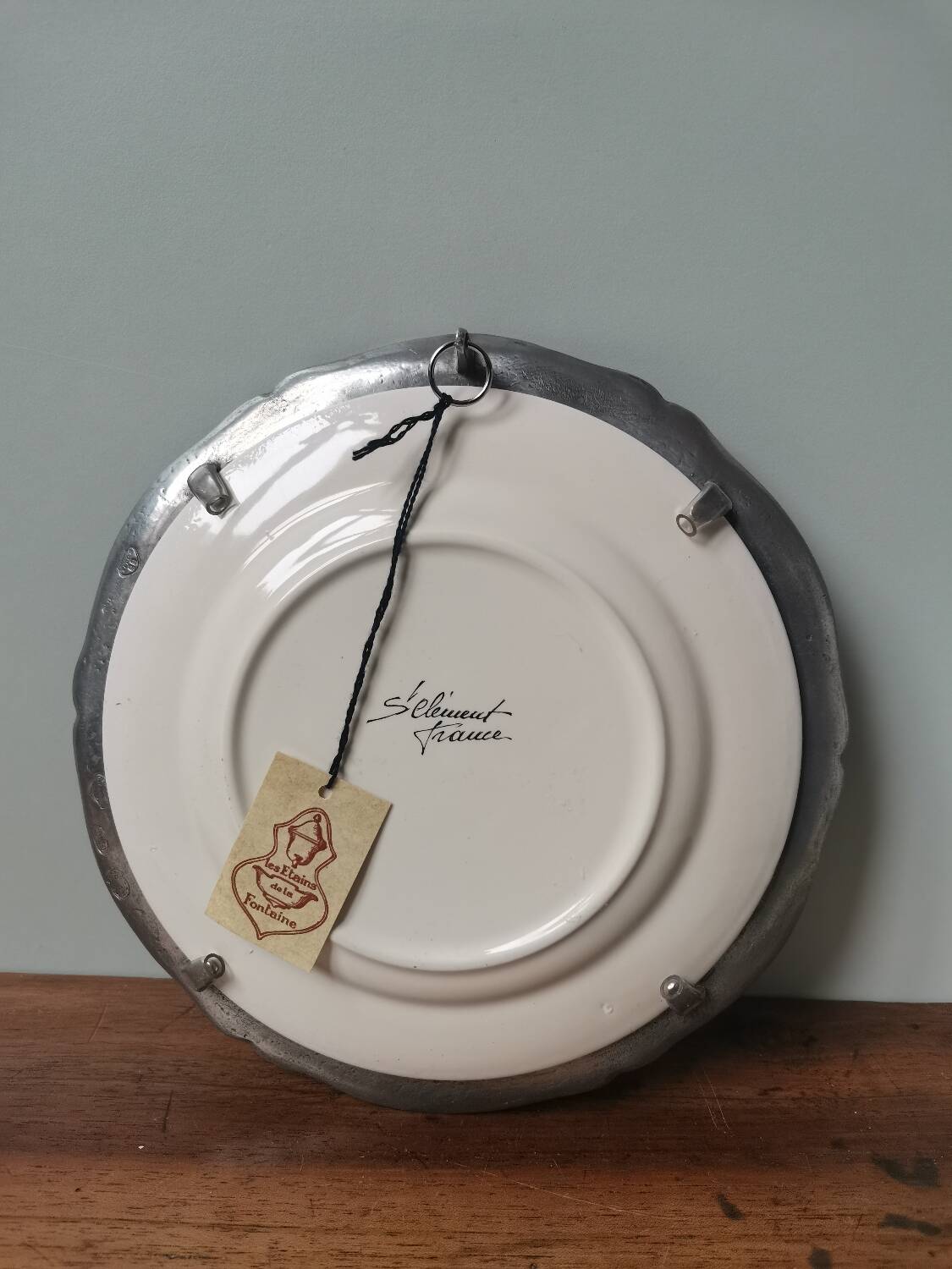Vintage St Clément plate to hang with pewter frame stamped pewter of the fountain France