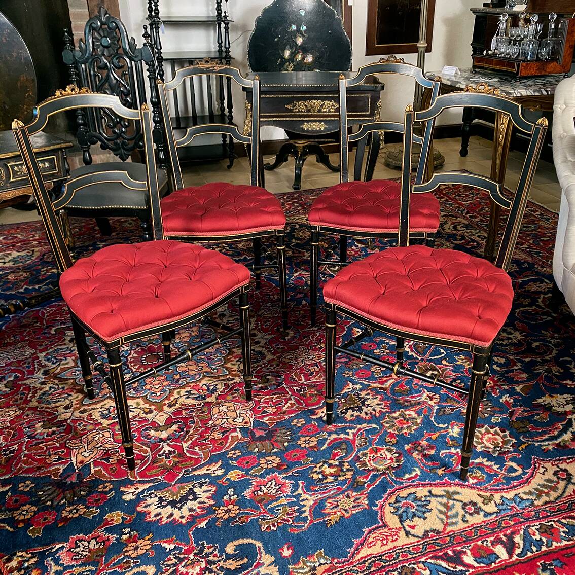Set of four Napoleon III chairs in black lacquered wood with gold highlights.