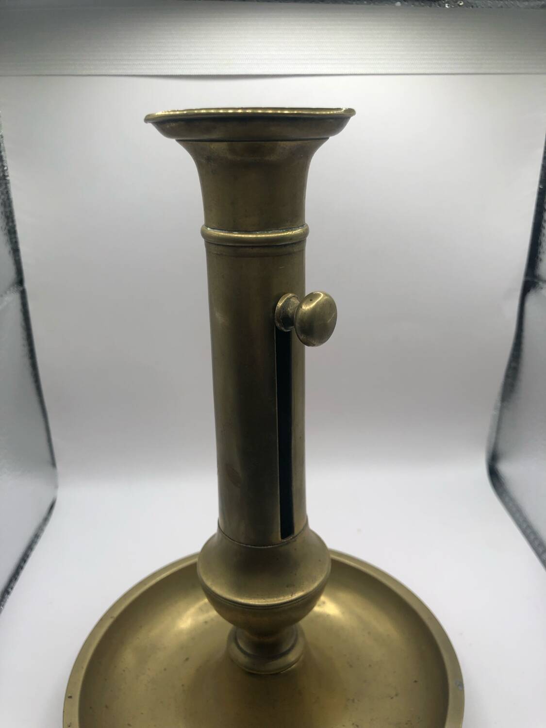 Candle holder with a pusher