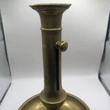 Candle holder with a pusher