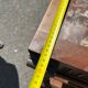 Carved wooden console table with three shelves and drop-leaf flap