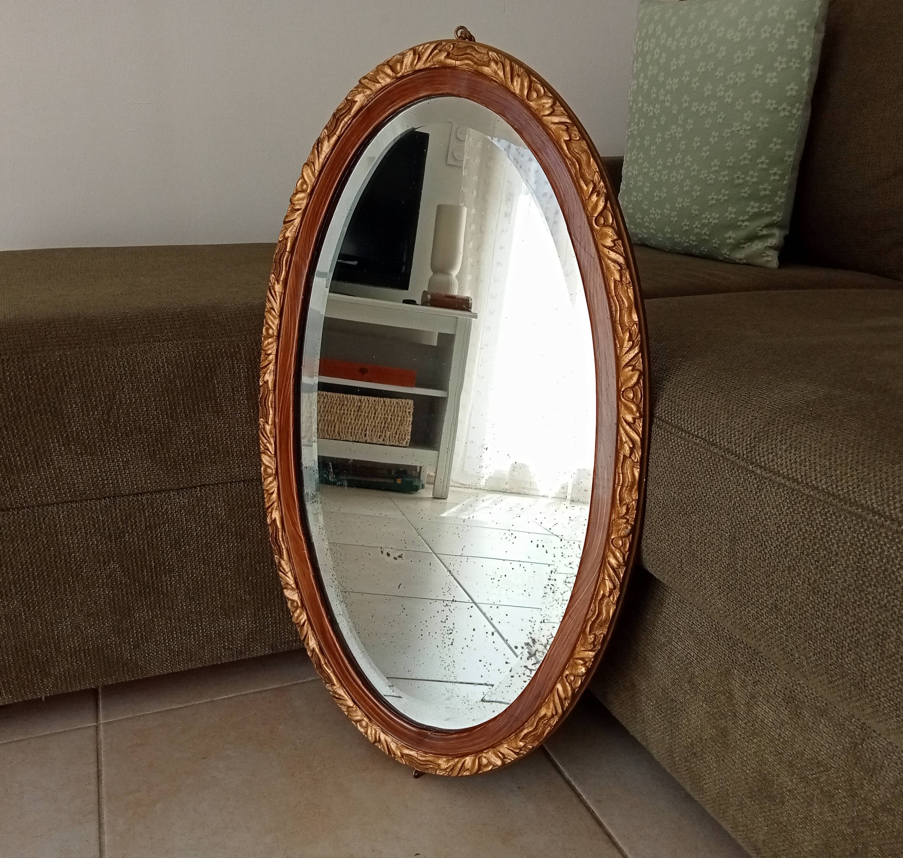 Antique oval mirror with beveled glass in wood and stucco, 19th century