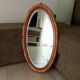 Antique oval mirror with beveled glass in wood and stucco, 19th century