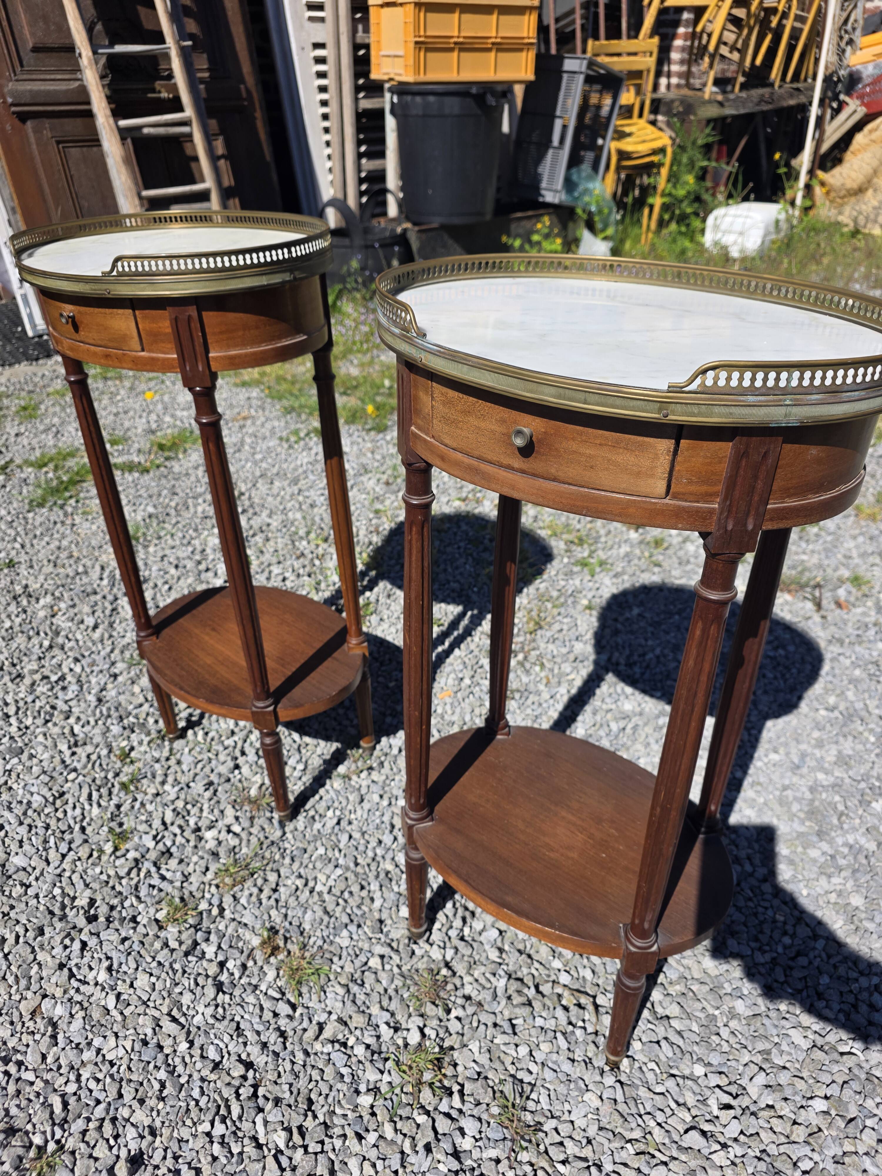 Pair of Louis XVI style bedside tables in mahogany, with marble tops.