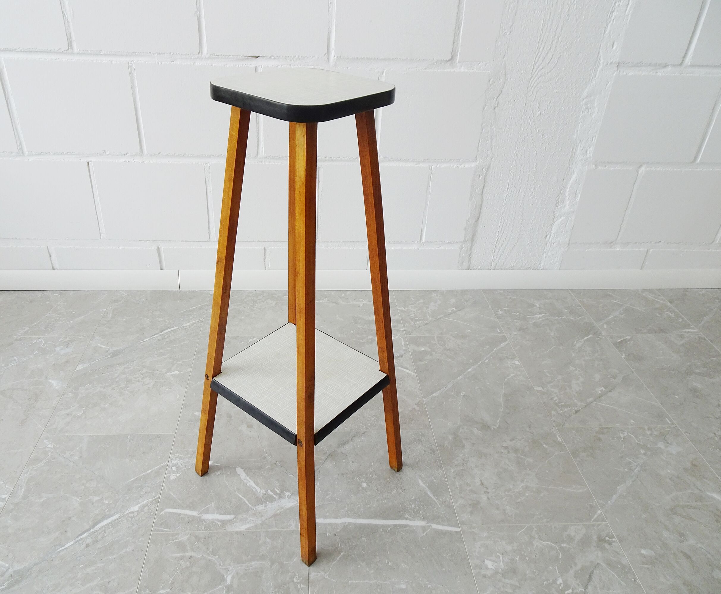 Plant stand made of wood and formica with two shelves, flower column