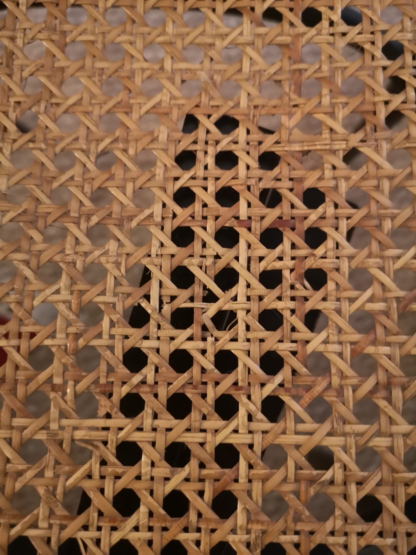 Blackened wooden chairs and cannage around 1980