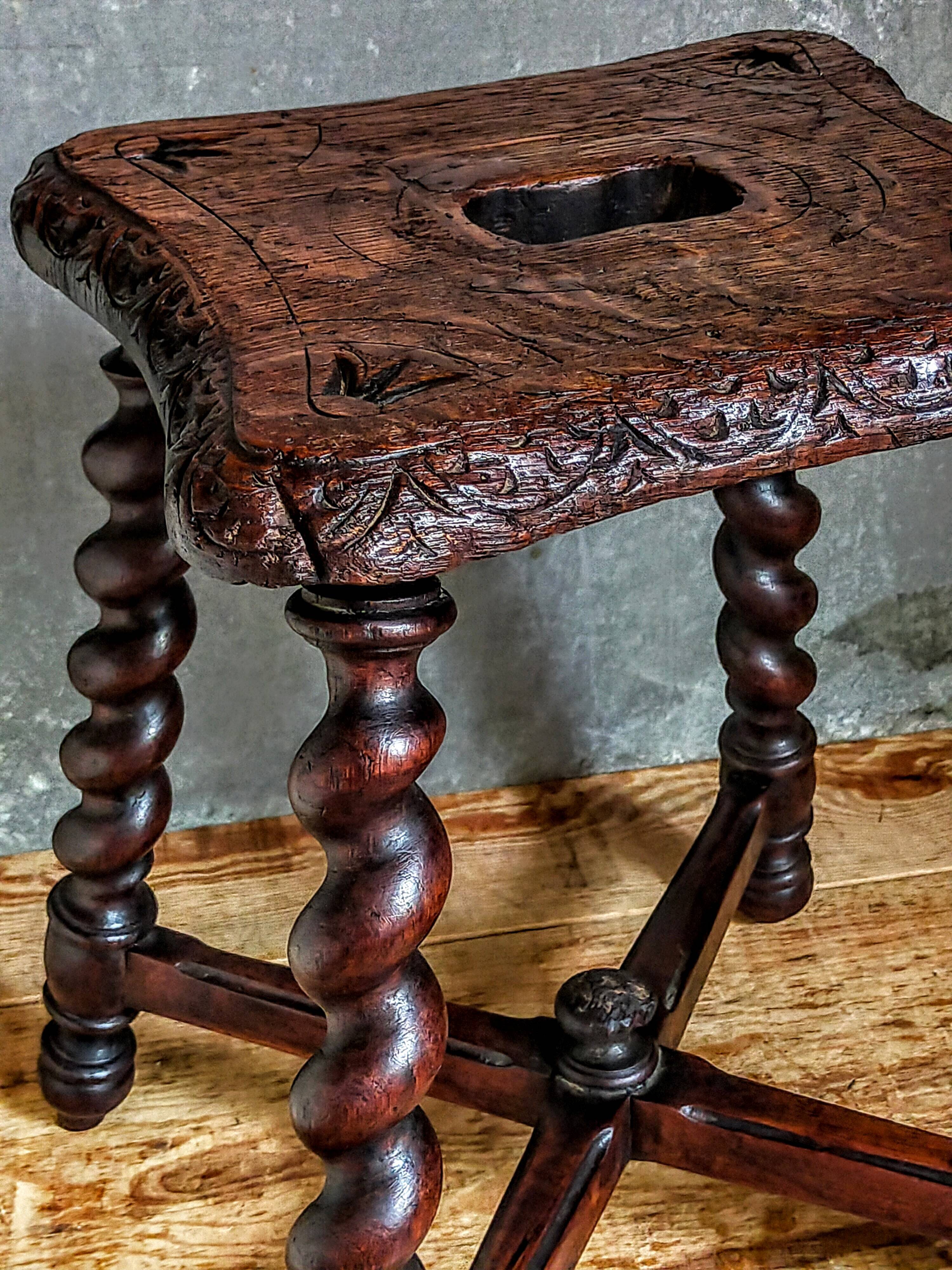 Antique stool in turned and carved solid wood