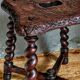 Antique stool in turned and carved solid wood