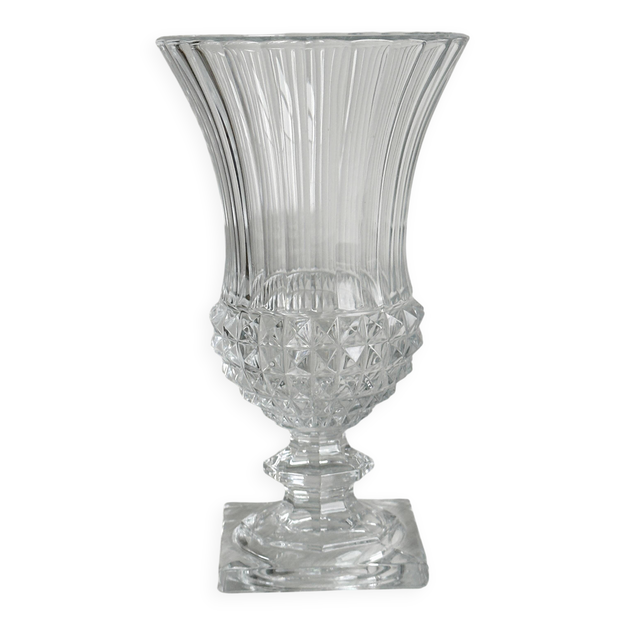 Antique thick glass vase on a pedestal.