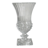 Antique thick glass vase on a pedestal.