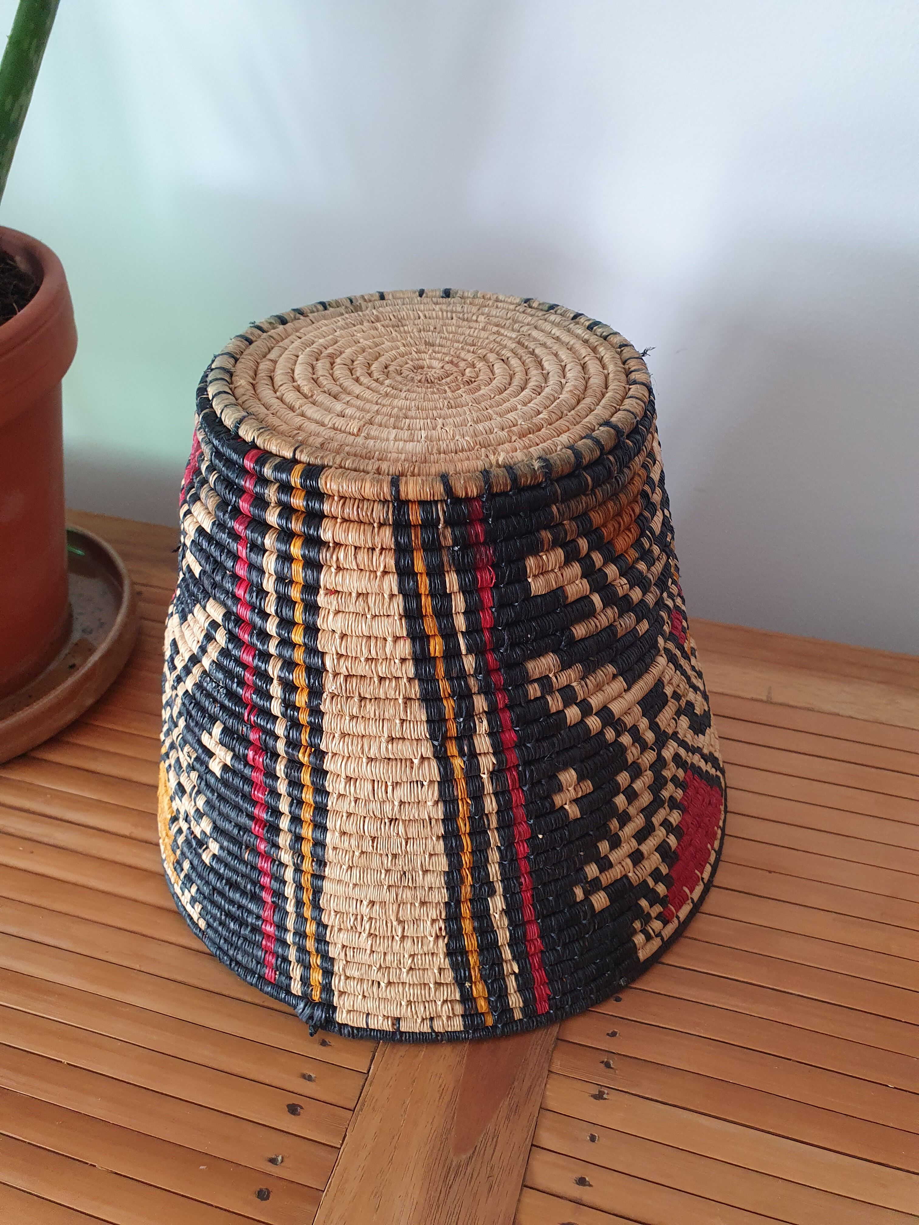 Ethnic basket in multicolored braided straw
