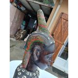 African statue of a woman, made of wood, brass, beads, and seashells.