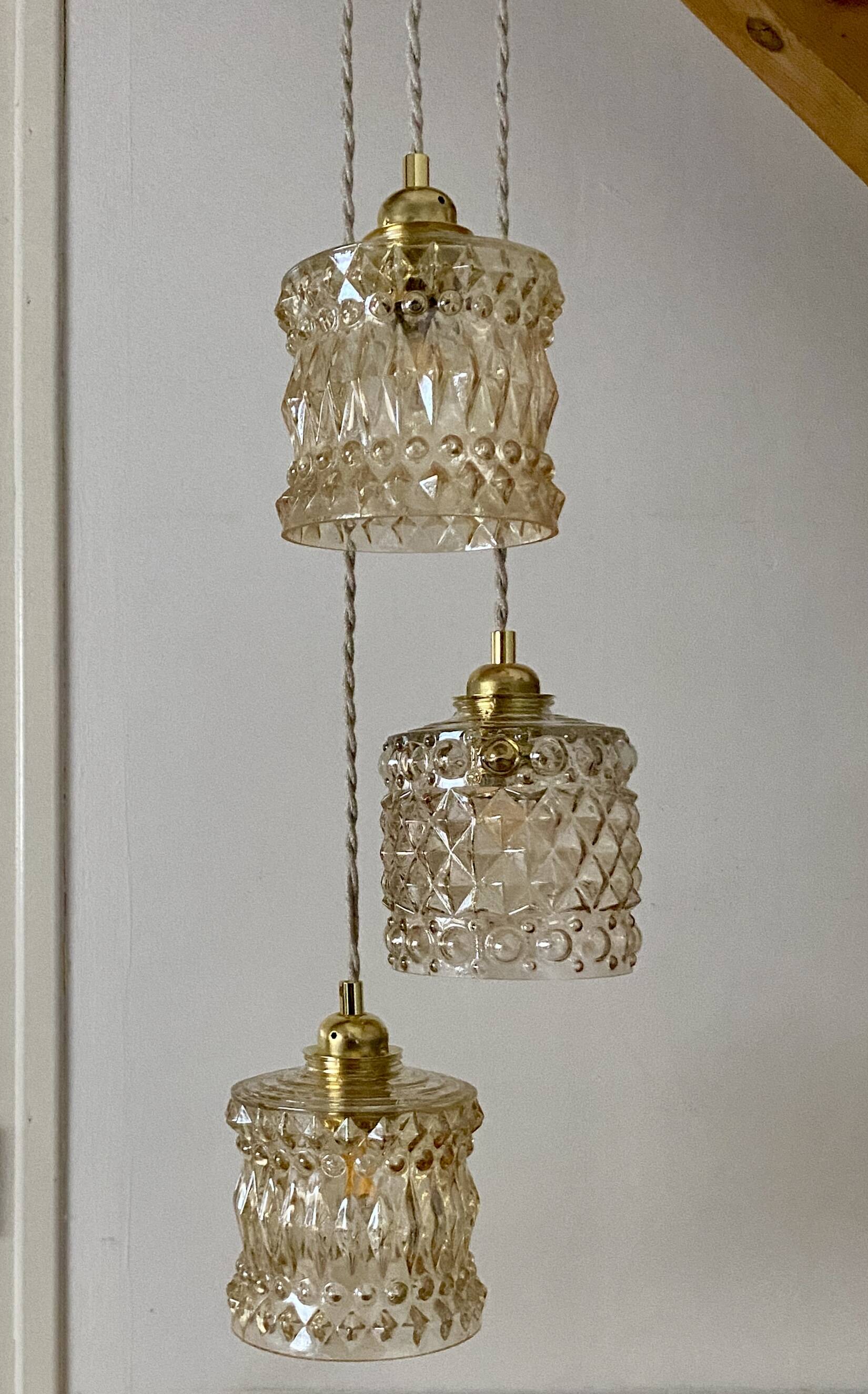 Triple antique globe pendant light in amber glass