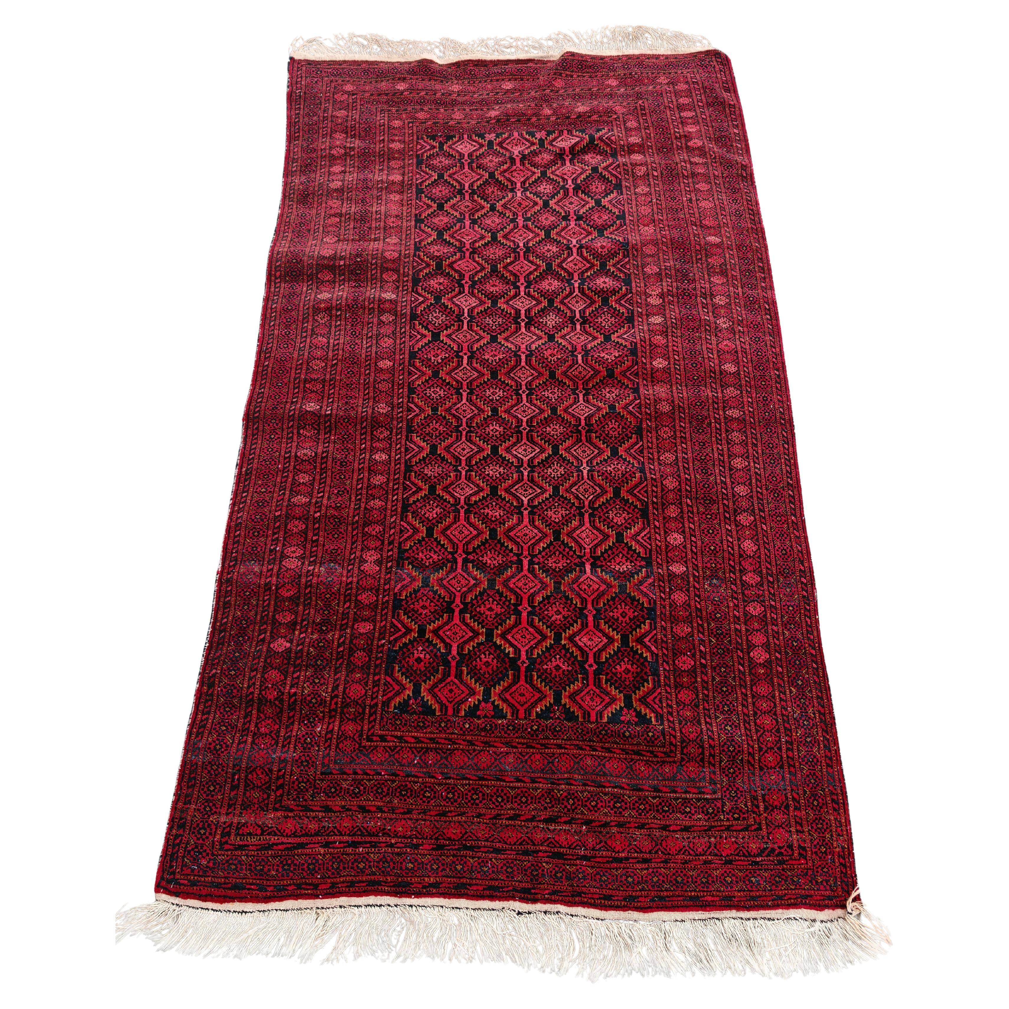 Vintage Baluch carpet handmade from natural wool, Afghanistan 1960.