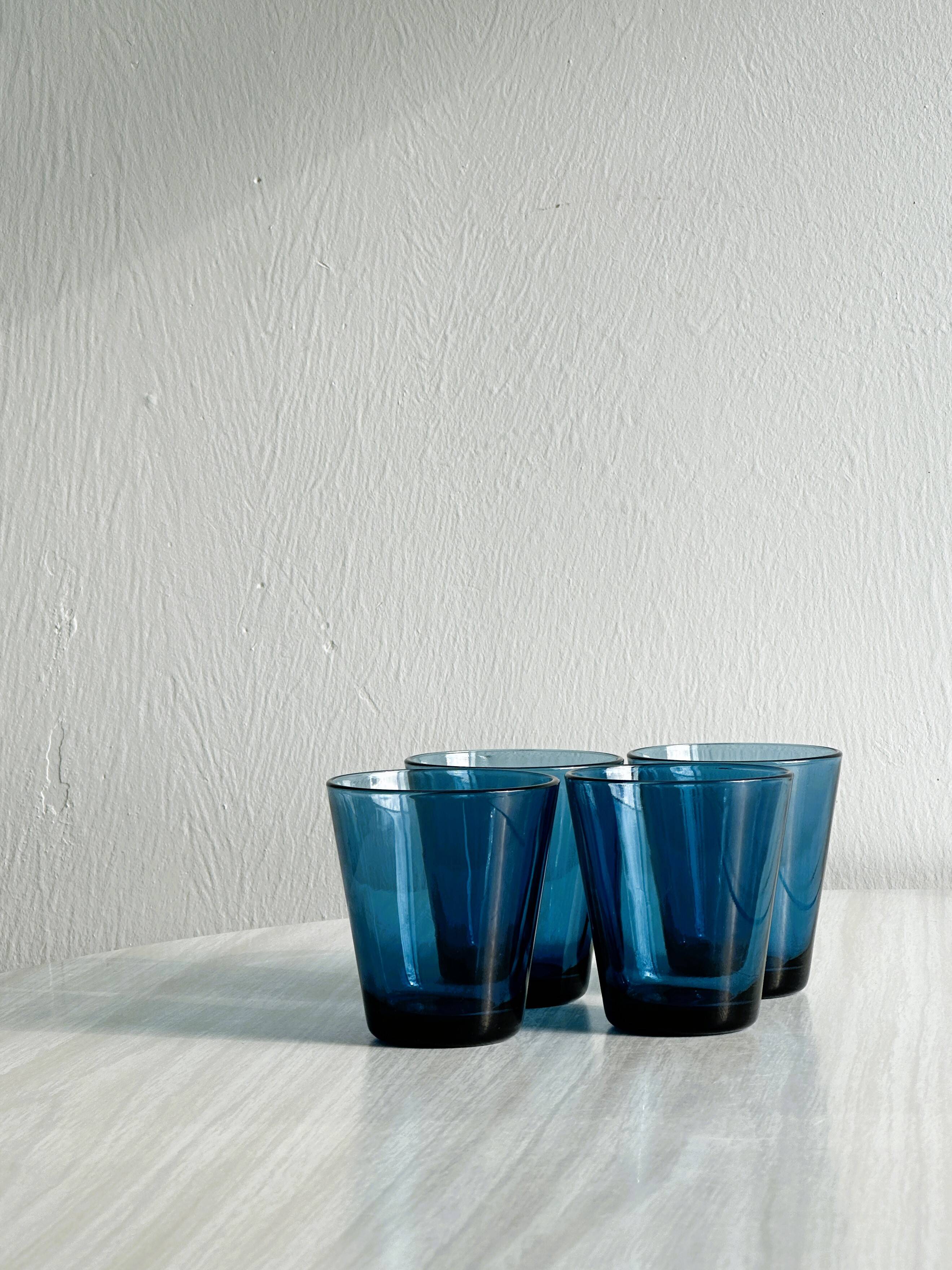 Four small translucent blue glasses.
